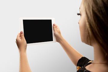 Image showing Close up female hands holding tablet with blank screen during online watching of popular sport matches and championships all around the world. Copyspace for ad