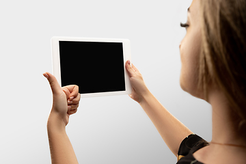 Image showing Close up female hands holding tablet with blank screen during online watching of popular sport matches and championships all around the world. Copyspace for ad