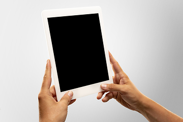 Image showing Close up male hands holding tablet with blank screen during online watching of popular sport matches and championships all around the world. Copyspace for ad