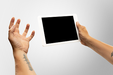 Image showing Close up male hands holding tablet with blank screen during online watching of popular sport matches and championships all around the world. Copyspace for ad