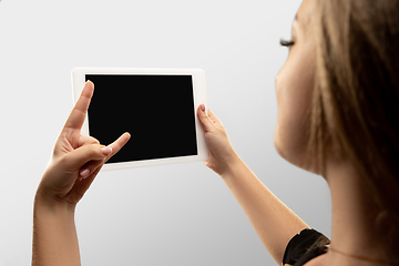 Image showing Close up female hands holding tablet with blank screen during online watching of popular sport matches and championships all around the world. Copyspace for ad