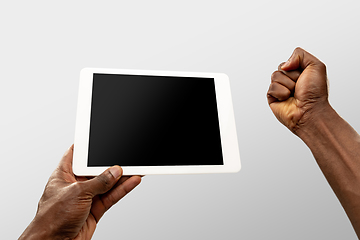 Image showing Close up male hands holding smartphone with blank screen during online watching of popular sport matches and championships all around the world. Copyspace for ad