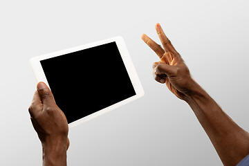 Image showing Close up male hands holding smartphone with blank screen during online watching of popular sport matches and championships all around the world. Copyspace for ad