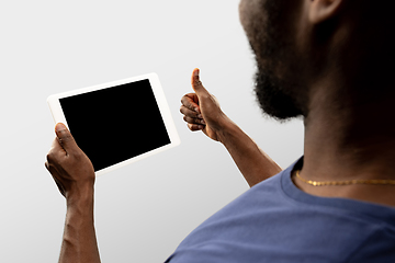 Image showing Close up male hands holding smartphone with blank screen during online watching of popular sport matches and championships all around the world. Copyspace for ad