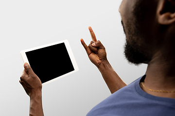 Image showing Close up male hands holding smartphone with blank screen during online watching of popular sport matches and championships all around the world. Copyspace for ad