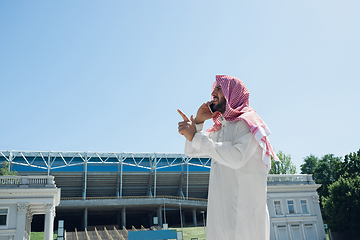 Image showing Smiling rich arabian man\'s buying real estate in the city