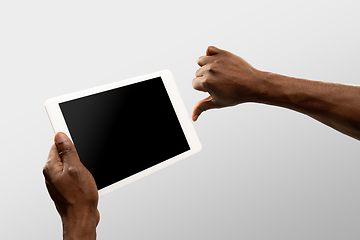 Image showing Close up male hands holding smartphone with blank screen during online watching of popular sport matches and championships all around the world. Copyspace for ad