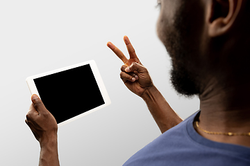 Image showing Close up male hands holding smartphone with blank screen during online watching of popular sport matches and championships all around the world. Copyspace for ad