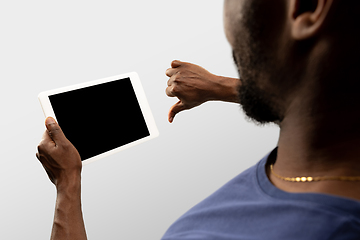 Image showing Close up male hands holding smartphone with blank screen during online watching of popular sport matches and championships all around the world. Copyspace for ad