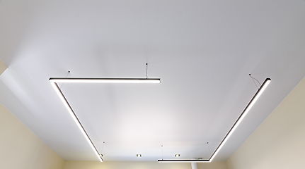 Image showing Modern white matte stretch ceiling with original fixtures