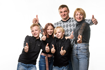 Image showing Portrait of an ordinary large family, everyone shows a thumbs up and joyfully looks into the frame