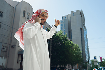 Image showing Smiling rich arabian man\'s buying real estate in the city