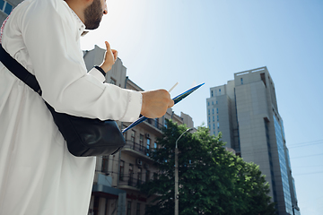 Image showing Smiling rich arabian man\'s buying real estate in the city