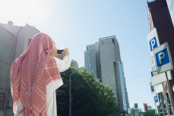 Image showing Smiling rich arabian man\'s buying real estate in the city