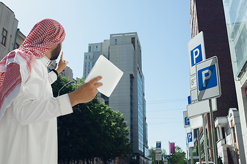 Image showing Smiling rich arabian man\'s buying real estate in the city