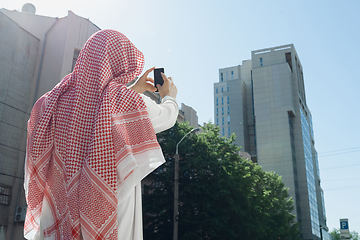 Image showing Smiling rich arabian man\'s buying real estate in the city