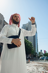 Image showing Smiling rich arabian man\'s buying real estate in the city