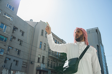 Image showing Smiling rich arabian man\'s buying real estate in the city