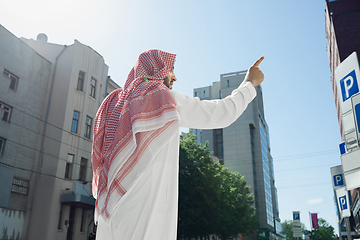 Image showing Smiling rich arabian man\'s buying real estate in the city