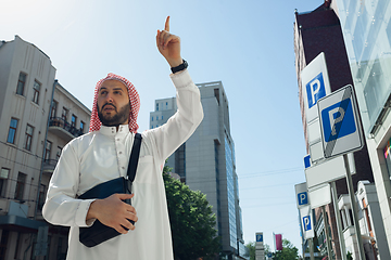 Image showing Smiling rich arabian man\'s buying real estate in the city