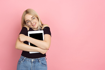 Image showing Portrait of young caucasian woman with bright emotions on coral pink studio background