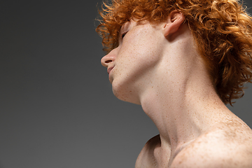 Image showing Portrait of beautiful redhead man isolated on grey studio background. Concept of beauty, skin care, fashion and style