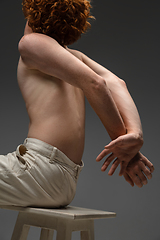 Image showing Portrait of beautiful redhead man isolated on grey studio background. Concept of beauty, skin care, fashion and style