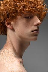 Image showing Portrait of beautiful redhead man isolated on grey studio background. Concept of beauty, skin care, fashion and style