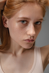 Image showing Portrait of beautiful redhead woman isolated on grey studio background. Concept of beauty, skin care, fashion and style