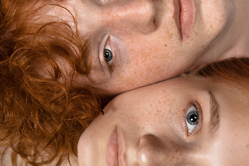 Image showing Portrait of beautiful redhead couple isolated on grey studio background. Concept of beauty, skin care, fashion and style