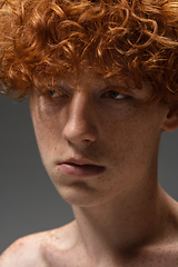 Image showing Portrait of beautiful redhead man isolated on grey studio background. Concept of beauty, skin care, fashion and style