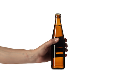 Image showing Empty golden colored beer bottle in male hand. Isolated on white studio background