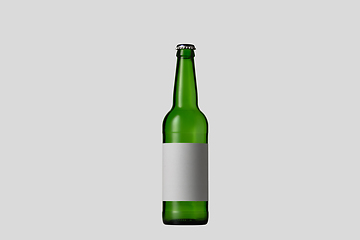 Image showing Empty green colored beer bottle. Isolated on white studio background