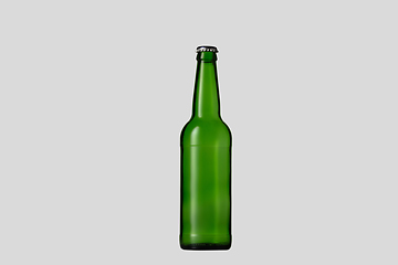 Image showing Empty green colored beer bottle. Isolated on white studio background