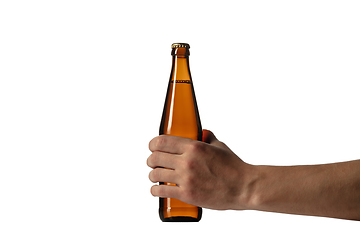 Image showing Empty golden colored beer bottle in male hand. Isolated on white studio background