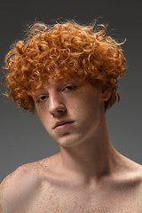 Image showing Portrait of beautiful redhead man isolated on grey studio background. Concept of beauty, skin care, fashion and style