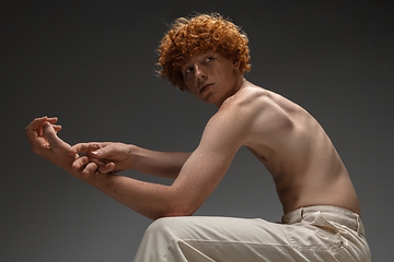 Image showing Portrait of beautiful redhead man isolated on grey studio background. Concept of beauty, skin care, fashion and style