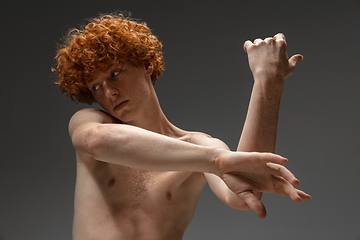 Image showing Portrait of beautiful redhead man isolated on grey studio background. Concept of beauty, skin care, fashion and style