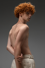 Image showing Portrait of beautiful redhead man isolated on grey studio background. Concept of beauty, skin care, fashion and style