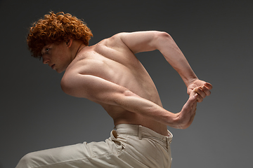 Image showing Portrait of beautiful redhead man isolated on grey studio background. Concept of beauty, skin care, fashion and style