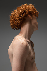 Image showing Portrait of beautiful redhead man isolated on grey studio background. Concept of beauty, skin care, fashion and style