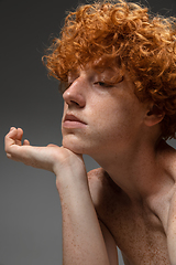 Image showing Portrait of beautiful redhead man isolated on grey studio background. Concept of beauty, skin care, fashion and style