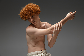 Image showing Portrait of beautiful redhead man isolated on grey studio background. Concept of beauty, skin care, fashion and style