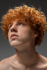 Image showing Portrait of beautiful redhead man isolated on grey studio background. Concept of beauty, skin care, fashion and style