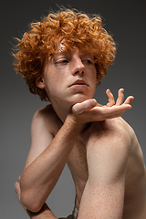 Image showing Portrait of beautiful redhead man isolated on grey studio background. Concept of beauty, skin care, fashion and style