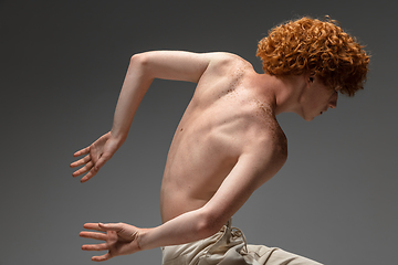 Image showing Portrait of beautiful redhead man isolated on grey studio background. Concept of beauty, skin care, fashion and style