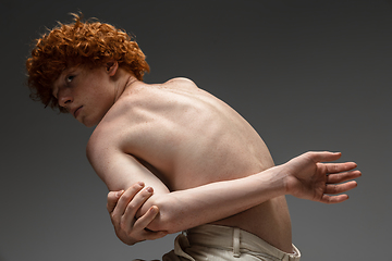 Image showing Portrait of beautiful redhead man isolated on grey studio background. Concept of beauty, skin care, fashion and style