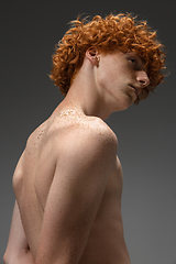 Image showing Portrait of beautiful redhead man isolated on grey studio background. Concept of beauty, skin care, fashion and style