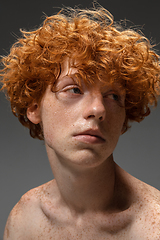 Image showing Portrait of beautiful redhead man isolated on grey studio background. Concept of beauty, skin care, fashion and style