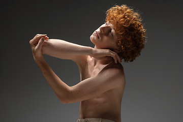 Image showing Portrait of beautiful redhead man isolated on grey studio background. Concept of beauty, skin care, fashion and style